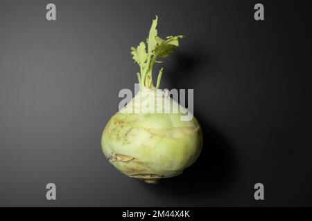 Kohlrabi or french  ripe green leaves. On a black background, close-up Stock Photo
