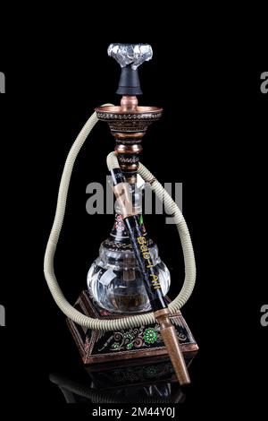 Modern old brass hookah isolated on black background. whole object copy paste Stock Photo