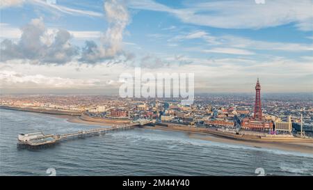 Blackpool Tower and sea front, aerial view over the Irish sea showing north pier and amusement arcades of holiday destination Stock Photo