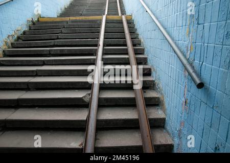 an old broken staircase up with a metal ramp Stock Photo