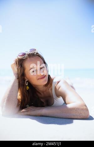 relaxed stylish woman laying at the beach Stock Photo - Alamy