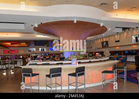 Nevada USA 05-09-21 Circular long tables surround the colorful 3535 Cocktail Bar located near the registration desk at The Linq Las Vegas hotel Stock Photo