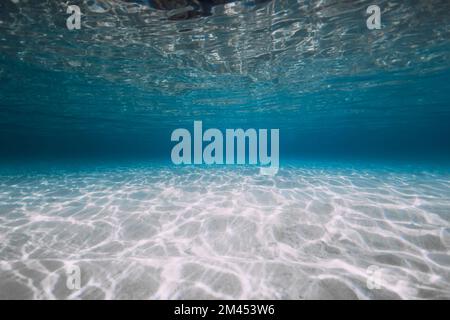 Blue ocean with white sand and sunlight under water. Transparent ocean background Stock Photo