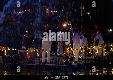 people playing traditional music on small boats or floating platforms Stock Photo