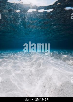 Tropical blue ocean with white sand underwater in Hawaiian island. Ocean background Stock Photo