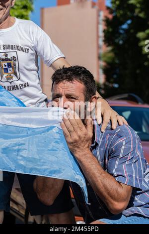 La Plata, Buenos Aires, Argentina - December 18, 2022: A fan kiss an Argentinian flag during the celebration of Argentina winning the 2022 FIFA World Stock Photo