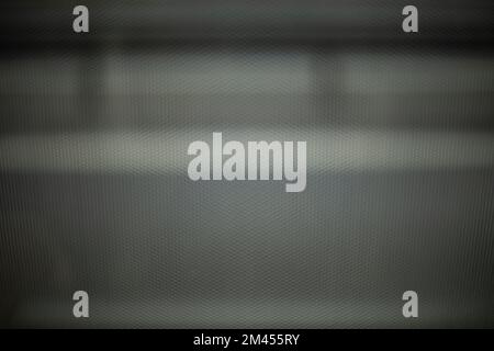 Texture of film on glass of bus. View through film to road. Blurred glass background. Gray dot. Stock Photo