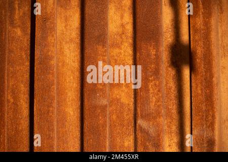Rusty steel. Steel fence. Spoiled metal. Rust in sunlight. Stock Photo