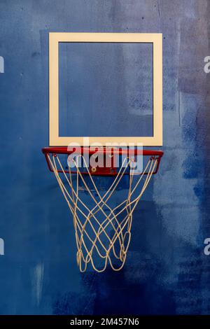 red basketball hoop with white woven net, detail background painting in blue Stock Photo