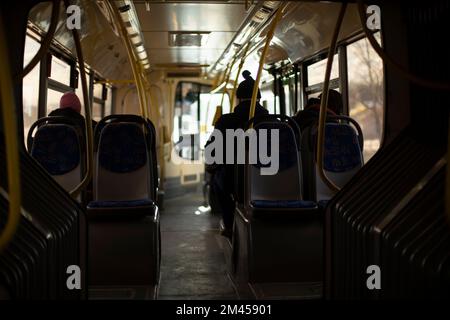 Inside bus. People go in transport. Salon of public transport. Stock Photo