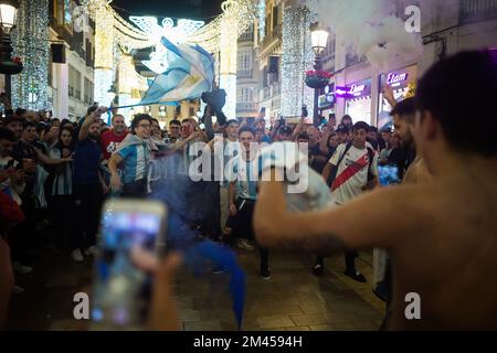 Malaga, Spain. 18th Dec, 2022. Argentinian fans are seen celebrating Argentina's victory on Marques de Larios street. Under a festive atmosphere, thousands of Argentinian residents in the city of Malaga have taken to the streets of the city center to celebrate the victory of the Argentine national football team, following their victory against France during the final of the FIFA World Cup Qatar 2022. (Photo by Jesus Merida/SOPA Images/Sipa USA) Credit: Sipa USA/Alamy Live News Stock Photo