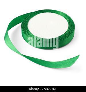 green color satin ribbon spool, close-up of textile ribbon reel isolated on white background, mock-up template with selective focus Stock Photo