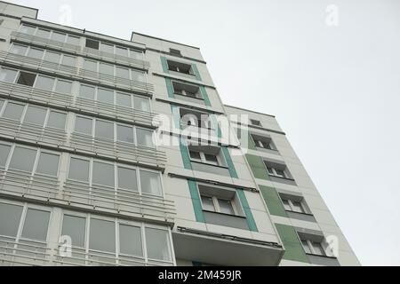 Building in city. Architecture details. Lots of windows in house. Urban development. Stock Photo