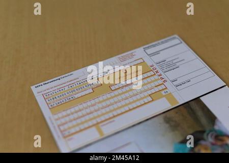 Freiburg, Germany. 15th Dec, 2022. ILLUSTRATION - A pre-filled donation transfer form from Caritas International lies on a table. Many people donated to help people in war-torn Ukraine. (to dpa 'Caritas: Ukraine war triggers large wave of donations ') Credit: Philipp von Ditfurth/dpa/Alamy Live News Stock Photo