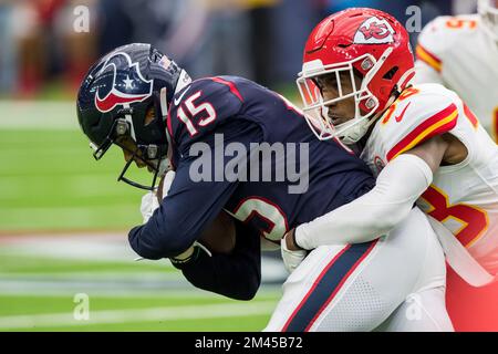 Houston, TX, USA. 18th Dec, 2022. Houston Texans wide receiver Chris Moore (15) is brought down by Kansas City Chiefs cornerback L'Jarius Sneed (38) during a game between the Kansas City Chiefs and the Houston Texans in Houston, TX. Trask Smith/CSM/Alamy Live News Stock Photo