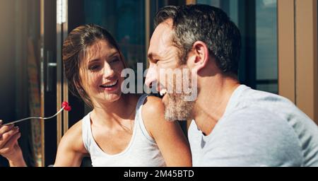 Heres a treat for you. an affectionate mature couple having lunch together outdoors. Stock Photo