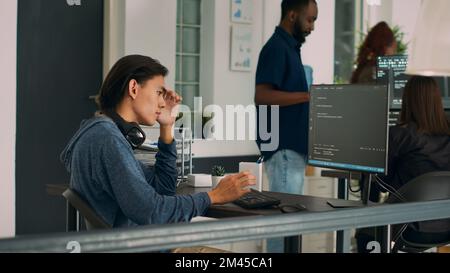 System engineer working with html script on terminal window, looking at computer screen and typing. Software developer in it office writing innovating ai algorithm and system programming. Stock Photo