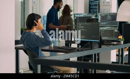 Database programer writing source code and developing security server with html script on computer. App developer typing on keyboard to create software program, computing big data. Stock Photo
