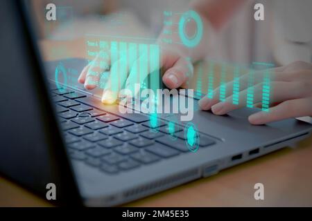 Woman using laptop analyzing and development at various information on futuristic virtual interface screen. Stock Photo