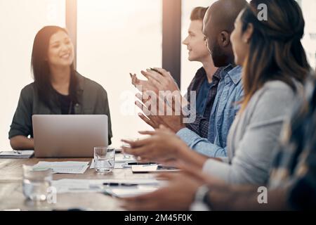 Good news deserves a round of applause. a group of young businesspeople clapping during a meeting in a modern office. Stock Photo