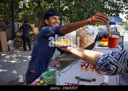 Young male vendor selling corn chat Stock Photo