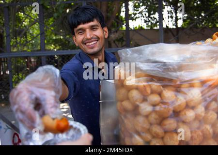 Portrait of a happy young male vendor selling panipuri Stock Photo