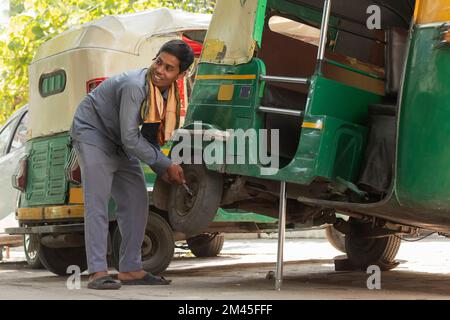 Young man repairing his auto rickshaw Stock Photo