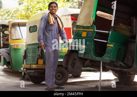 Young man repairing his auto rickshaw Stock Photo