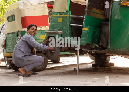 Young man repairing his auto rickshaw Stock Photo