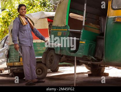 Young man repairing his auto rickshaw Stock Photo