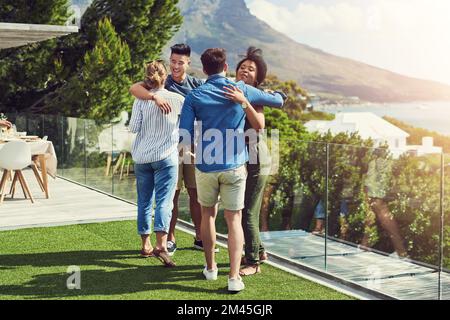 Welcome to the party guys. a group of friends having drinks and enjoying themselves outdoors while on holiday. Stock Photo