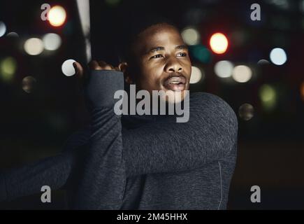 Black man, fitness and stretching at night in the city for workout, exercise or preparation in the outdoors. African American male in evening warm up Stock Photo