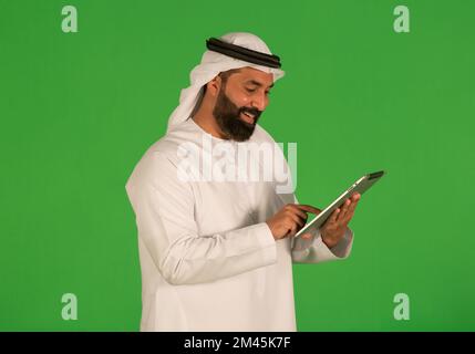 Emirati man using a digital tablet. Stock Photo