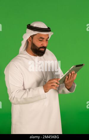 Emirati man using a digital tablet. Stock Photo