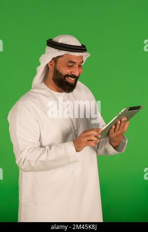Emirati man using a digital tablet. Stock Photo