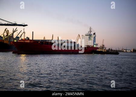 Vessel dry cargo on loading, unloading in port. Bulker in port. Stock Photo