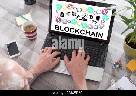 Blockchain concept shown on a laptop used by a man Stock Photo