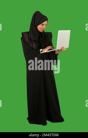 Portrait of arab businesswoman holding laptop. Stock Photo