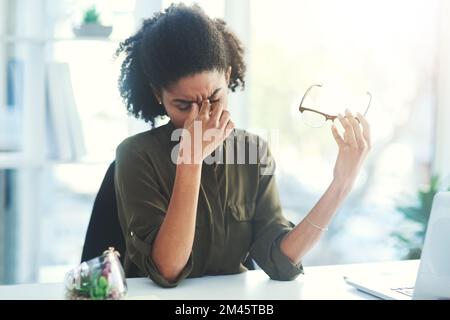 Stressing hinders creativity, calm down and rethink. a young businesswoman looking overly stressed in her office. Stock Photo