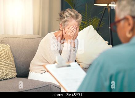 Crying, sad or old woman in counseling with a psychologist for depression, burnout or mental health problems. Checklist, consulting or depressed Stock Photo