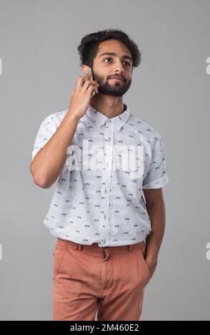 Portrait of an Expat Arab talking on the phone. Stock Photo