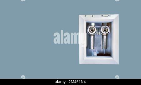 Close up water supply hose in the wall for washing machine, laundry outlet box, isolated, with clipping path Stock Photo