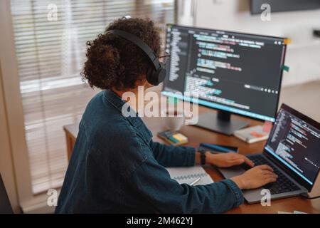 Female freelancer making new project as web designer and programmer on her computer at home office Stock Photo