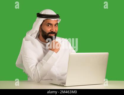 Emirati man working on a laptop. Stock Photo