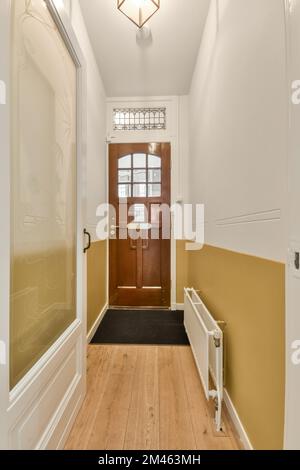 Corridor leading to a residential apartment with a parquet floor and carpet in a cozy house Stock Photo