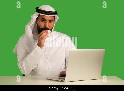 Emirati man working on a laptop. Stock Photo