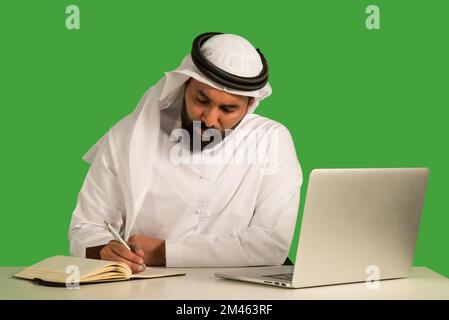Emirati man working on a laptop. Stock Photo