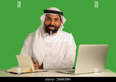 Emirati man working on a laptop. Stock Photo