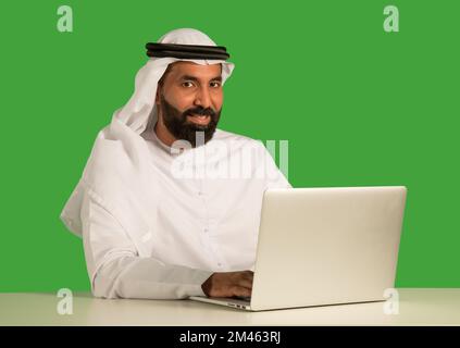 Emirati man working on a laptop. Stock Photo