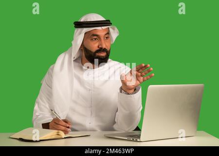 Emirati man working on a laptop. Stock Photo